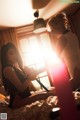 A couple of women sitting on top of a bed.