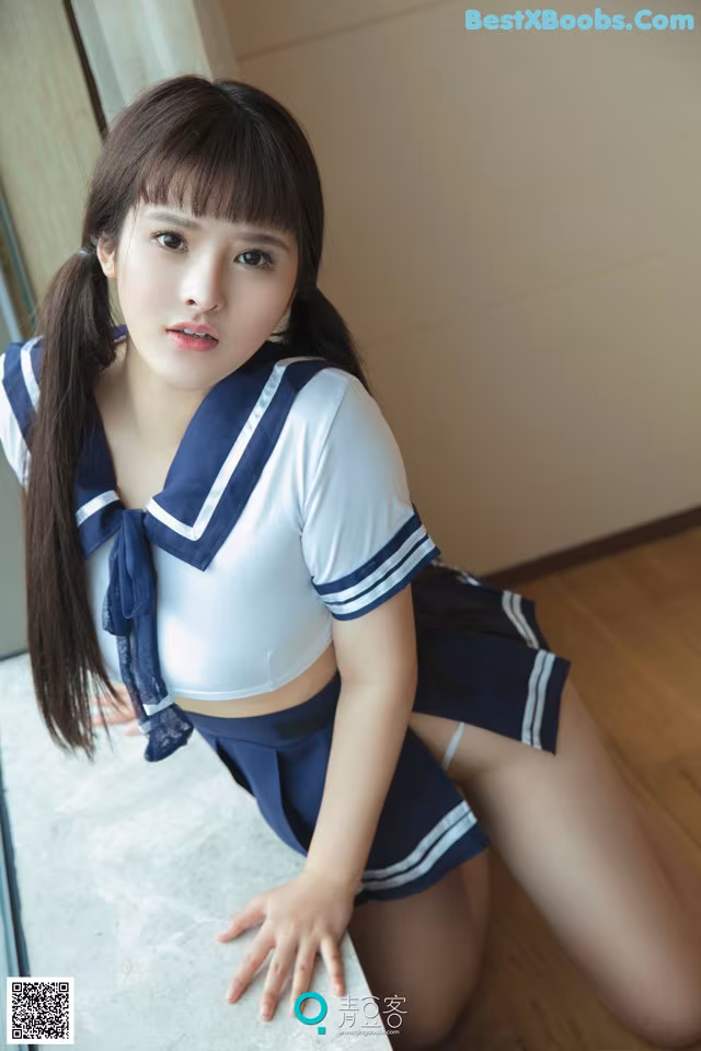 A woman in a school uniform posing for a picture.